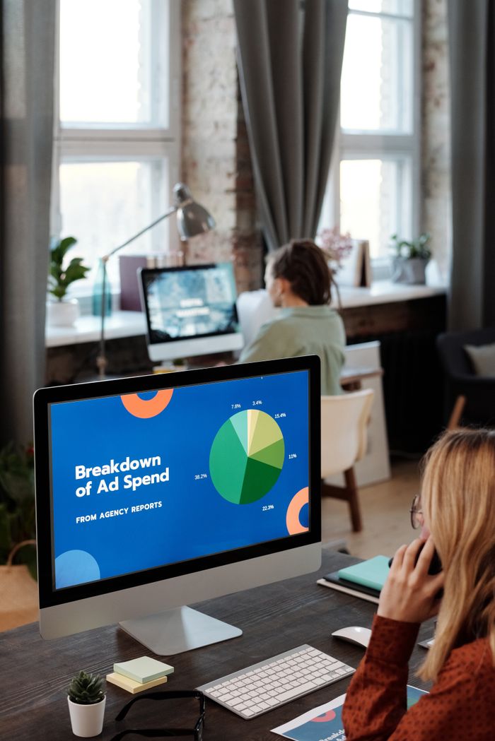 A bright office environment with computers showing data, highlighting productivity in a work setting.